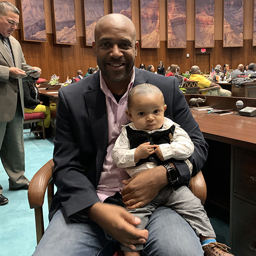 Brent Whiting holding baby Lorenzo on the AZ House floor